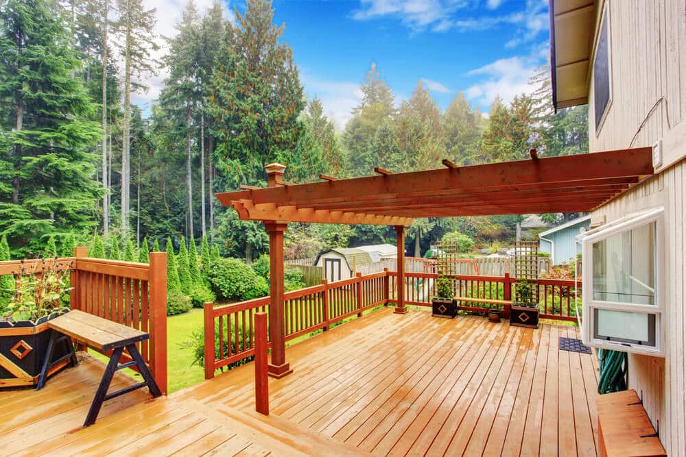Walkout deck with an attached pergola, an example of a pergola-covered outdoor space