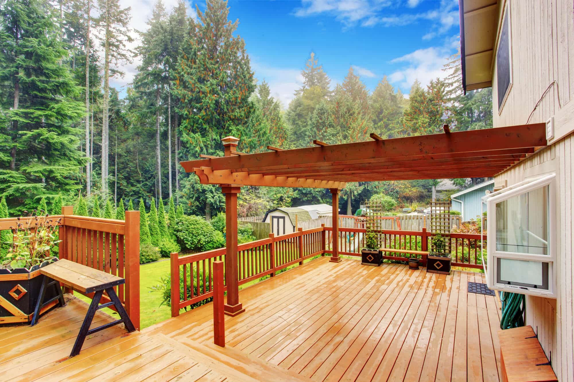 Deck with an attached pergola and mixed material accents for added curb appeal