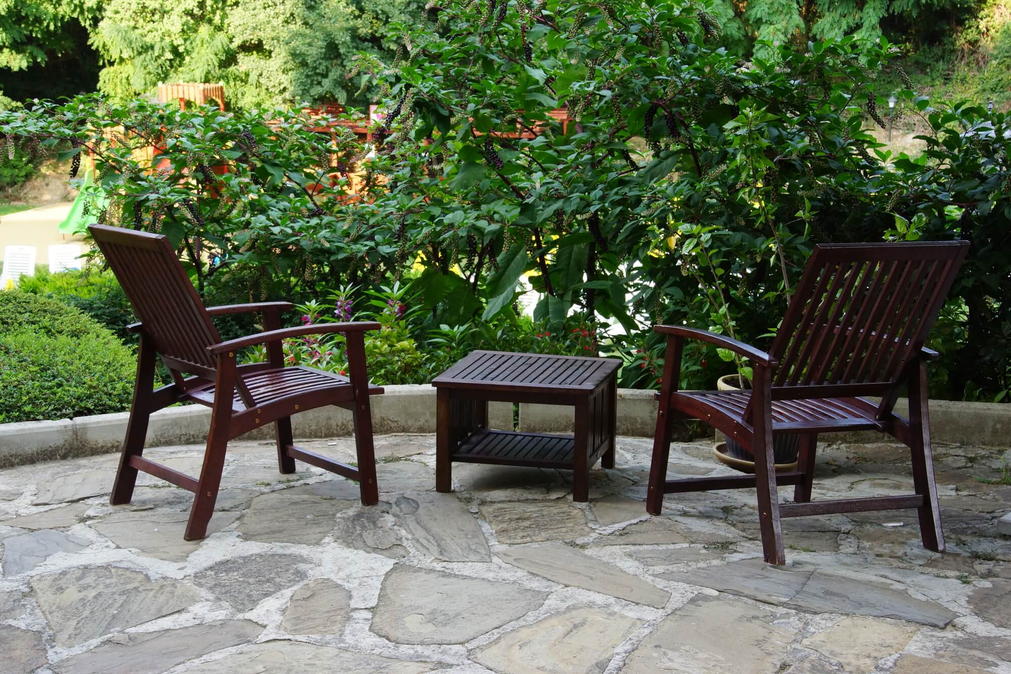 Budget-friendly patio surrounded by greenery, an example of a low-cost patio upgrade