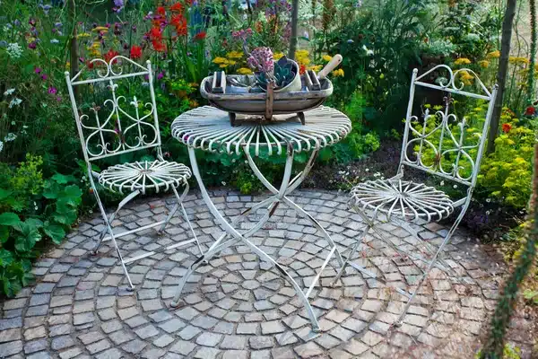 Paver patio in a garden setting designed for low-maintenance outdoor relaxation